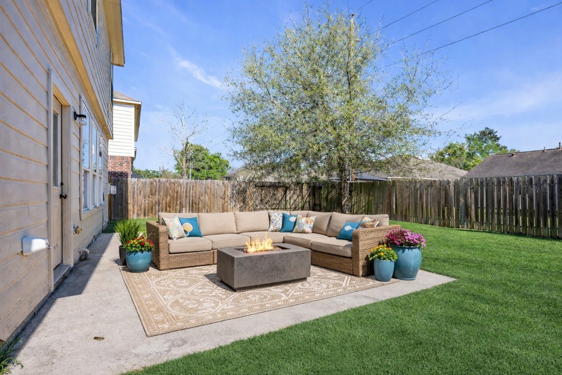 5026 Forest Hurst Drive Spring, TX 77373 - Photo 28 of 31 a view of a patio with couches and a table and chairs with wooden fence