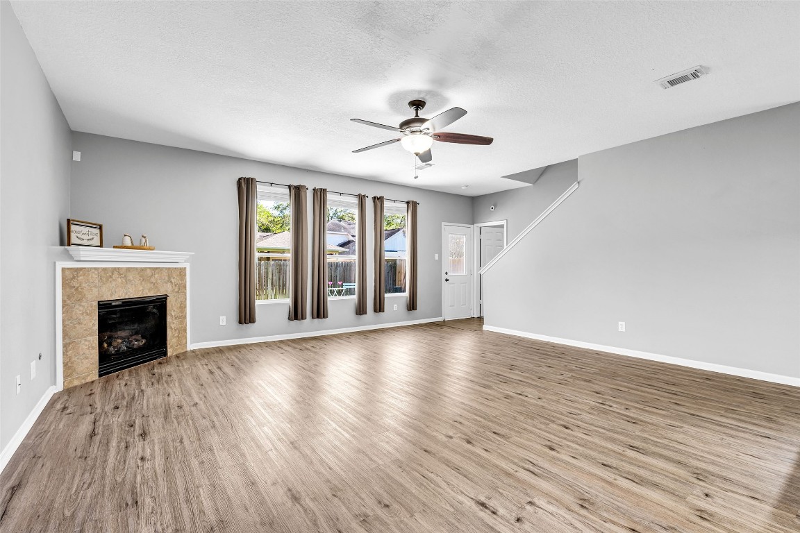 5026 Forest Hurst Drive Spring, TX 77373 - Photo 4 of 31 a view of an empty room with wooden floor and a fireplace