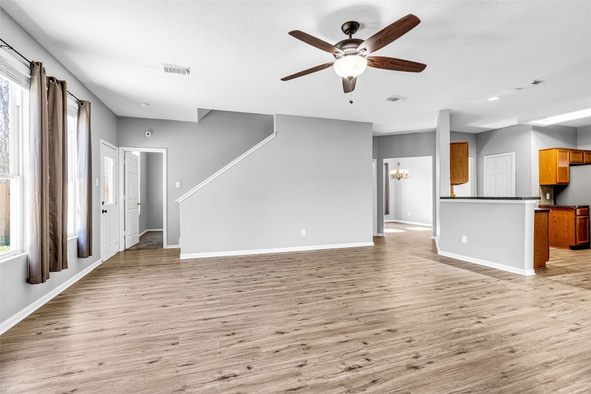 5026 Forest Hurst Drive Spring, TX 77373 - Photo 7 of 31 a view of a kitchen with wooden floor and a ceiling fan