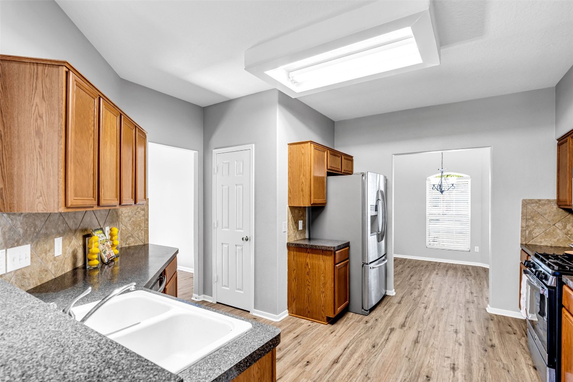 5026 Forest Hurst Drive Spring, TX 77373 - Photo 9 of 31 a kitchen with sink refrigerator and window