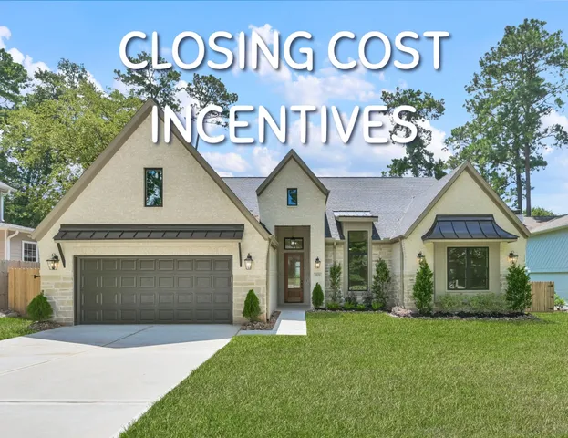 a front view of a house with a garden and garage