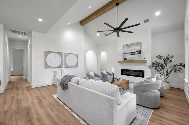 a living room with fireplace furniture and a wooden floor