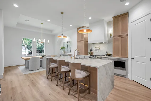 a kitchen with a sink cabinets and wooden floor