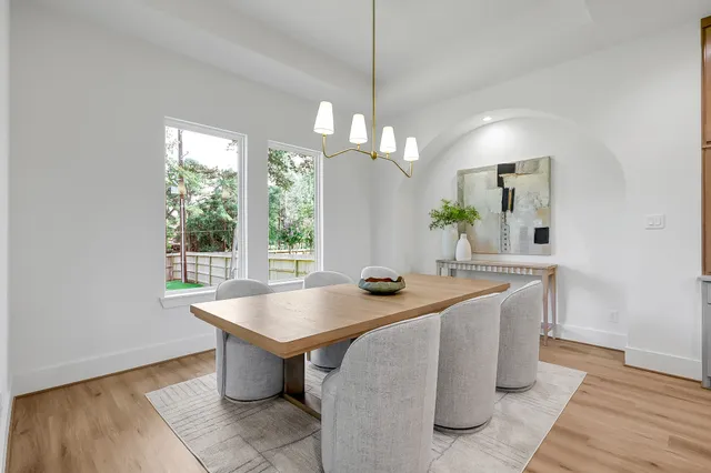 a room with pool table and windows