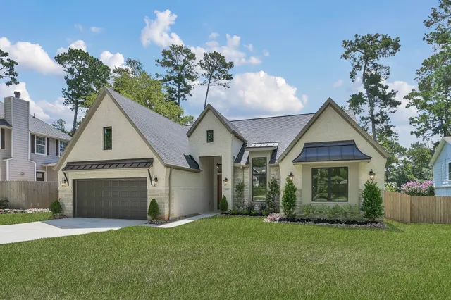 a front view of a house with a garden and plants