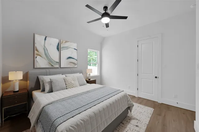 a bedroom with a bed and a painting on the wall