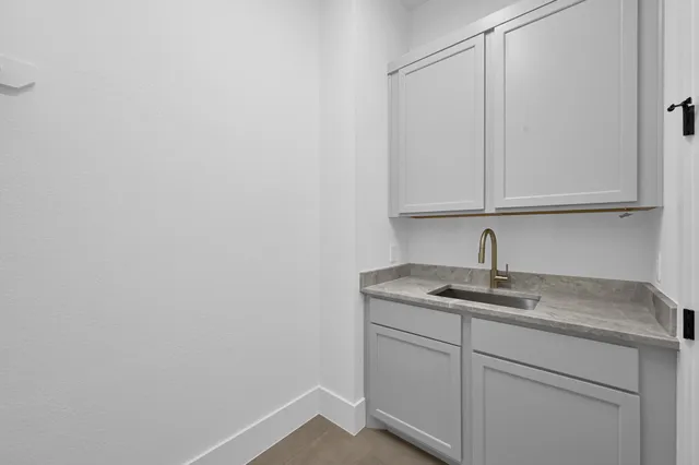 a kitchen with a sink and cabinets