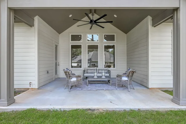 a view of a house with backyard and a patio