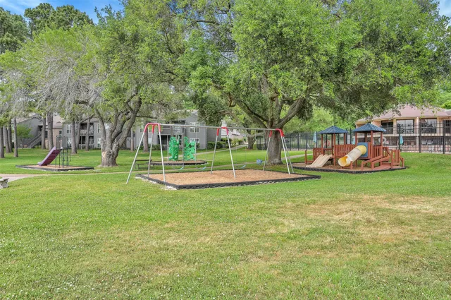 a view of a park with swings and slides
