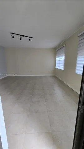 a view of a livingroom with furniture and a flat screen tv
