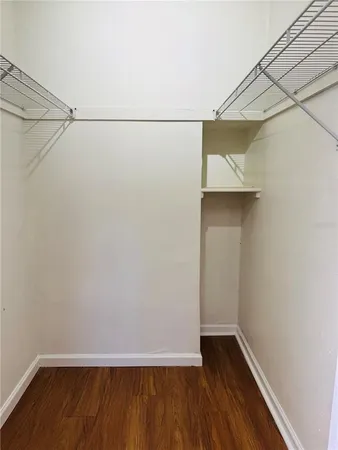 a view of small space with racks on the wall and a window