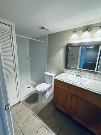 a bathroom with a double vanity sink mirror and toilet