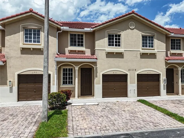 a front view of a house with a yard and garage