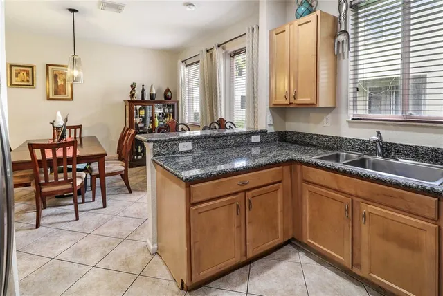 a kitchen with stainless steel appliances granite countertop a sink and a cabinets