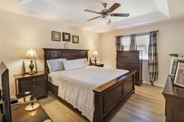 a spacious bedroom with a bed and a chandelier