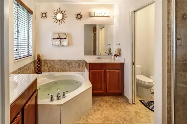 a bathroom with a tub sink and mirror