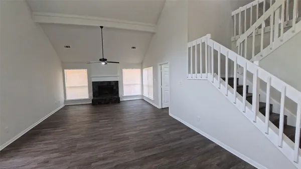 a view interior of a house with wooden floor fireplace and windows