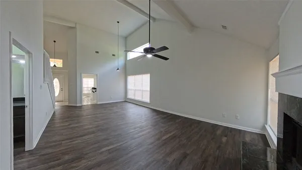 a view of a room with wooden floor