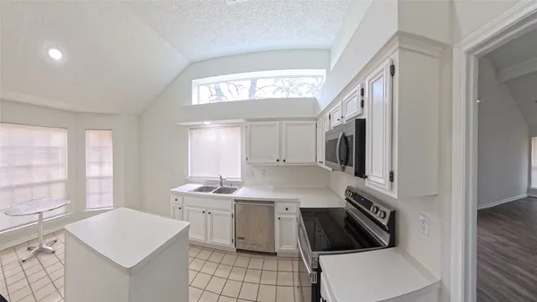 a kitchen with a sink stove and microwave
