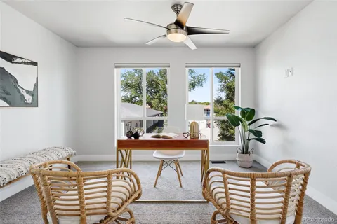 a living room with furniture a chandelier and a window