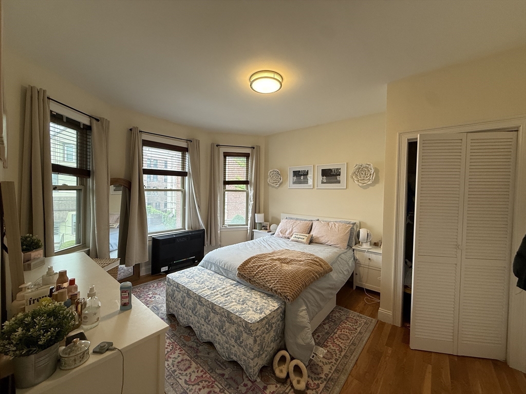 106 Chester Street, Unit 2 Boston, MA 02134 - Photo 4 of 9 a bedroom with a bed and wooden floor