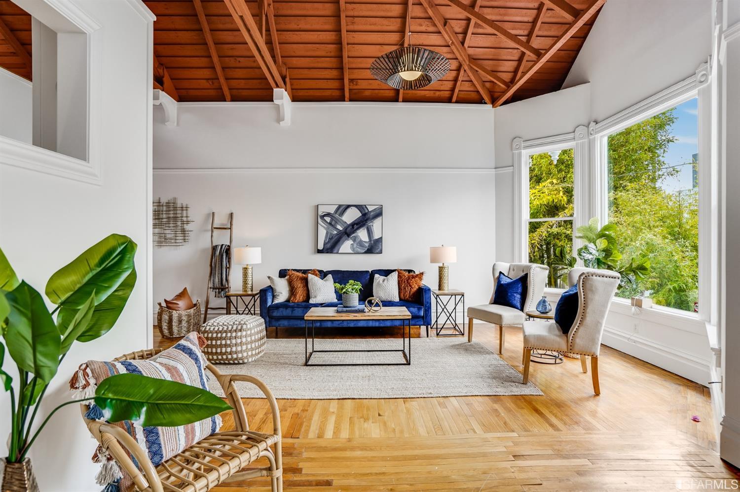 a living room with patio furniture and a potted plant