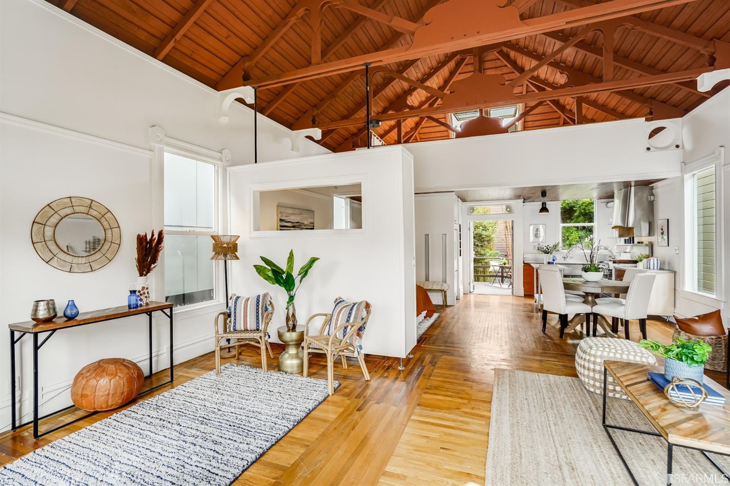 1366 34th Street Oakland, CA 94608 - Photo 13 of 51 a living room with furniture a table and wooden floor