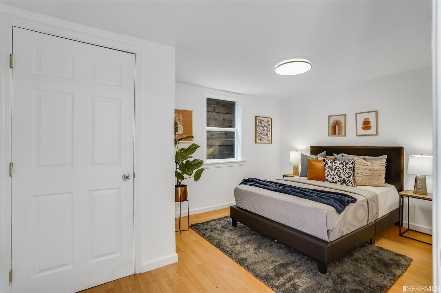 1366 34th Street Oakland, CA 94608 - Photo 41 of 51 a spacious bedroom with a bed and a window