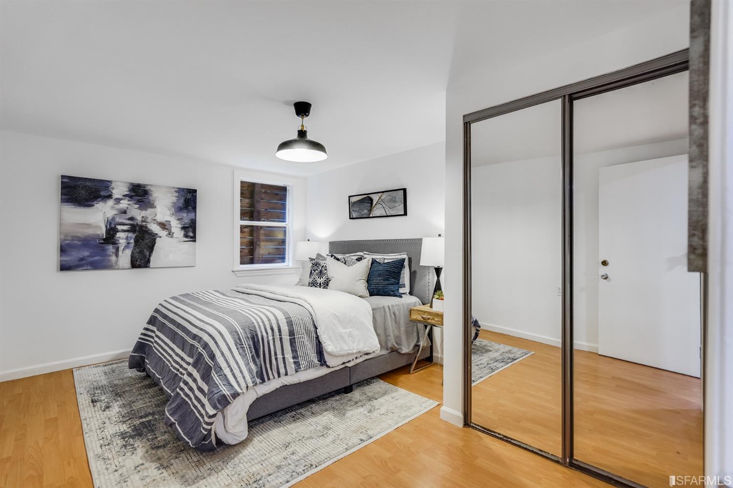 1366 34th Street Oakland, CA 94608 - Photo 43 of 51 a bedroom with a bed and a chandelier