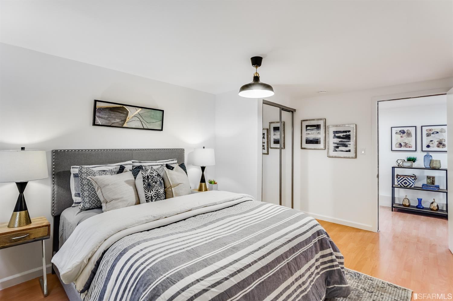 1366 34th Street Oakland, CA 94608 - Photo 44 of 51 a bedroom with a bed and wooden floor