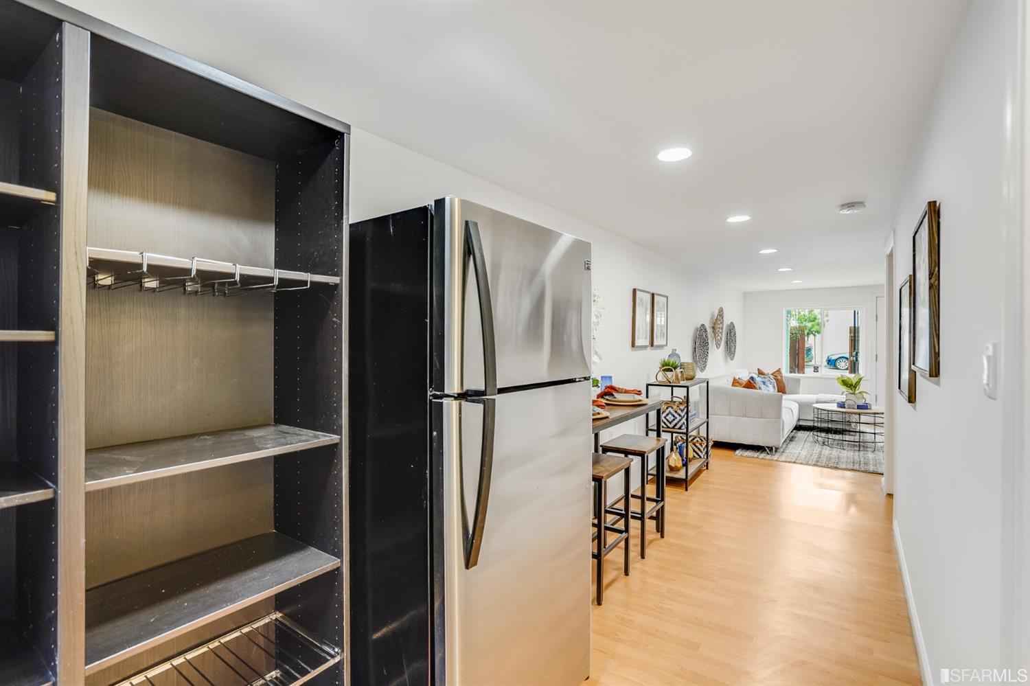 1366 34th Street Oakland, CA 94608 - Photo 46 of 51 a view of a kitchen with furniture and a refrigerator