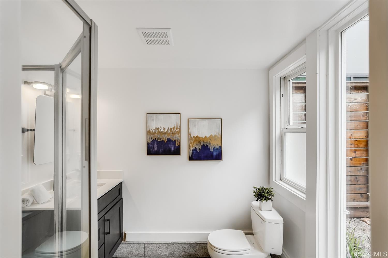 1366 34th Street Oakland, CA 94608 - Photo 48 of 51 a bathroom with a toilet sink and mirror