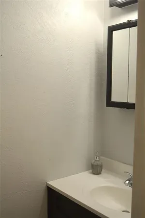 a bathroom with a sink and mirror