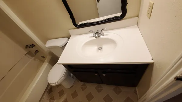 a bathroom with a sink and mirror