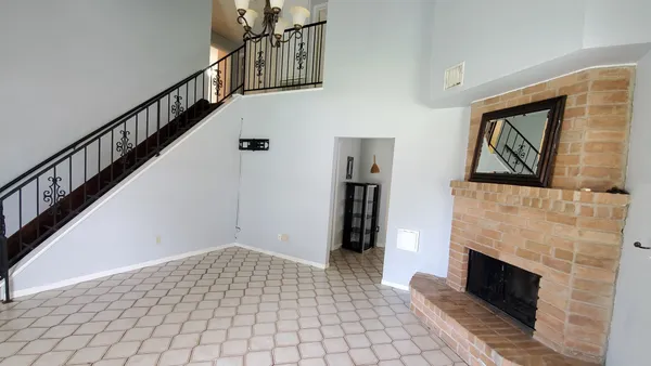 a view of entryway and hall with a fireplace