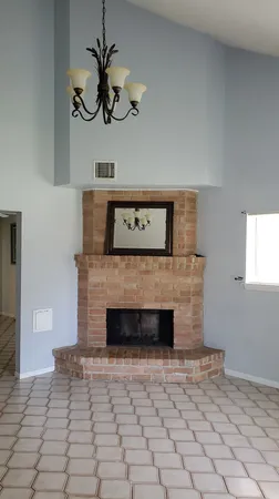 a view of empty room with a fireplace