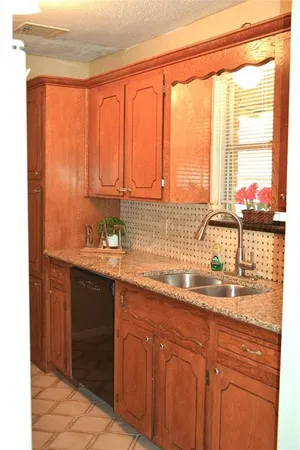 a kitchen with stainless steel appliances granite countertop a sink and a white cabinets