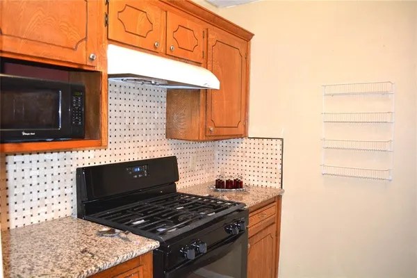 a stove top oven sitting inside of a kitchen
