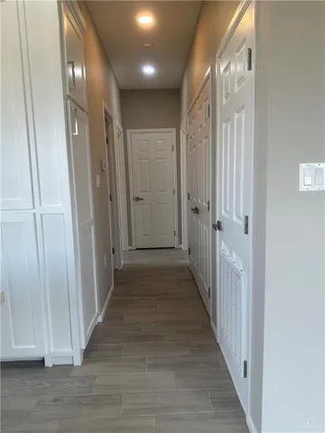 a view of a hallway with wooden floor