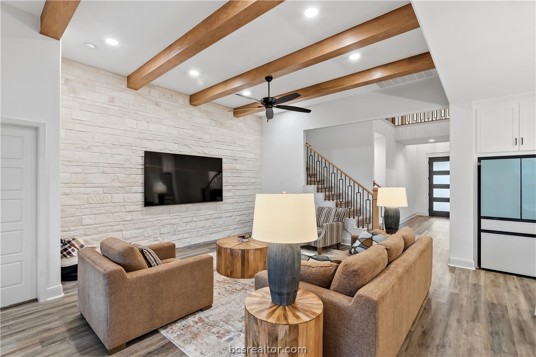 3500 Castine Court Bryan, TX 77808 - Photo 9 of 46 Gorgeous living room with upgraded stone wall. The 85" TV is included!