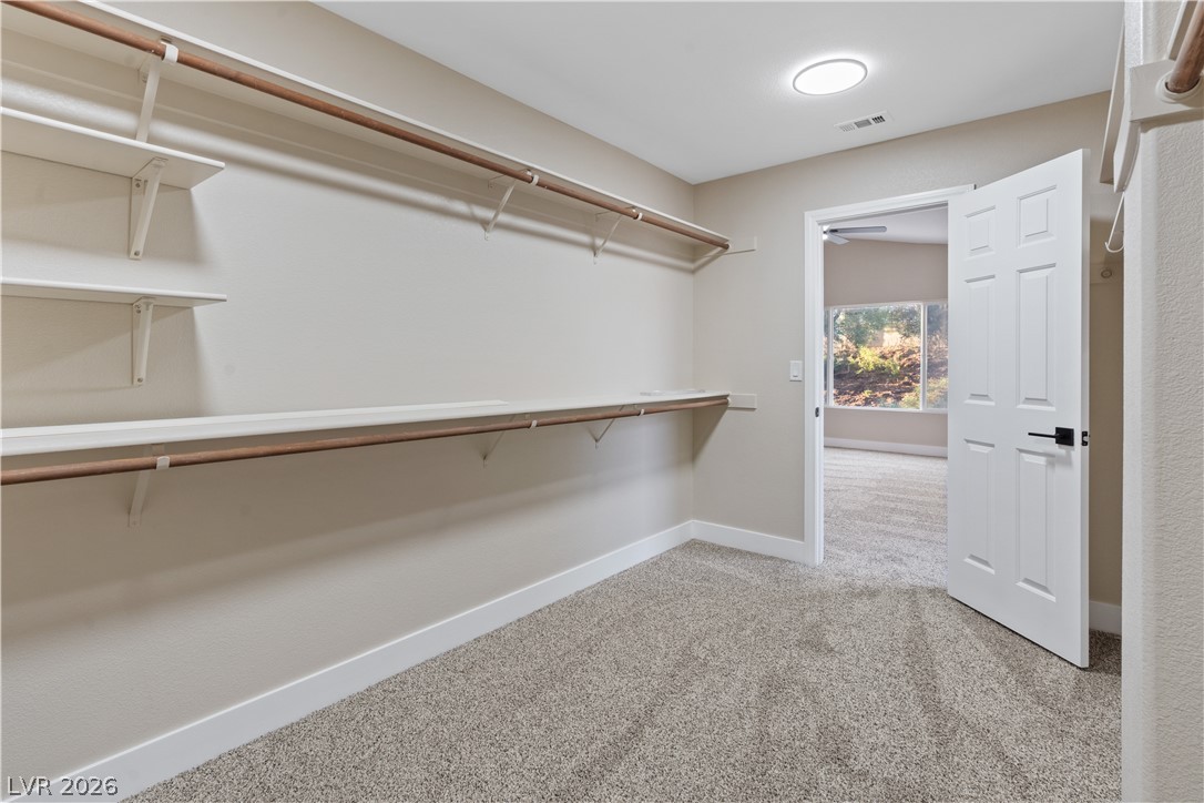 1662 Ravanusa Drive Henderson, NV 89052 - Photo 35 of 74 A spacious primary closet features ample shelving and hanging rods, ideal for effortless organization.