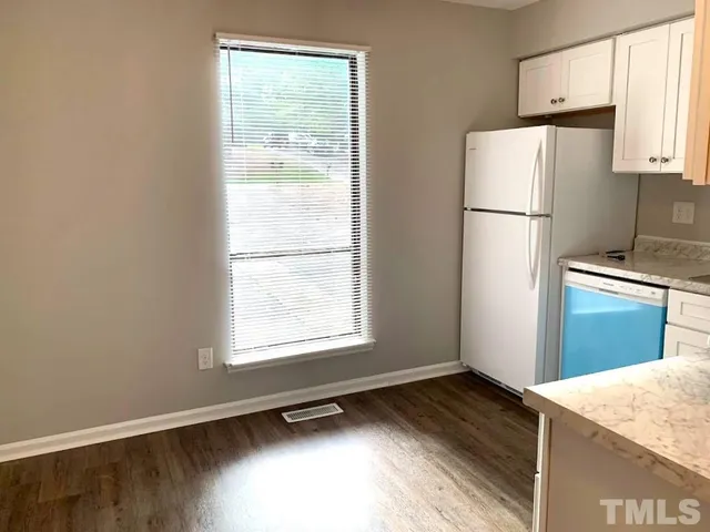 a kitchen with a refrigerator a stove top oven