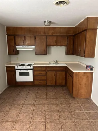 a kitchen with stainless steel appliances granite countertop a sink and cabinets