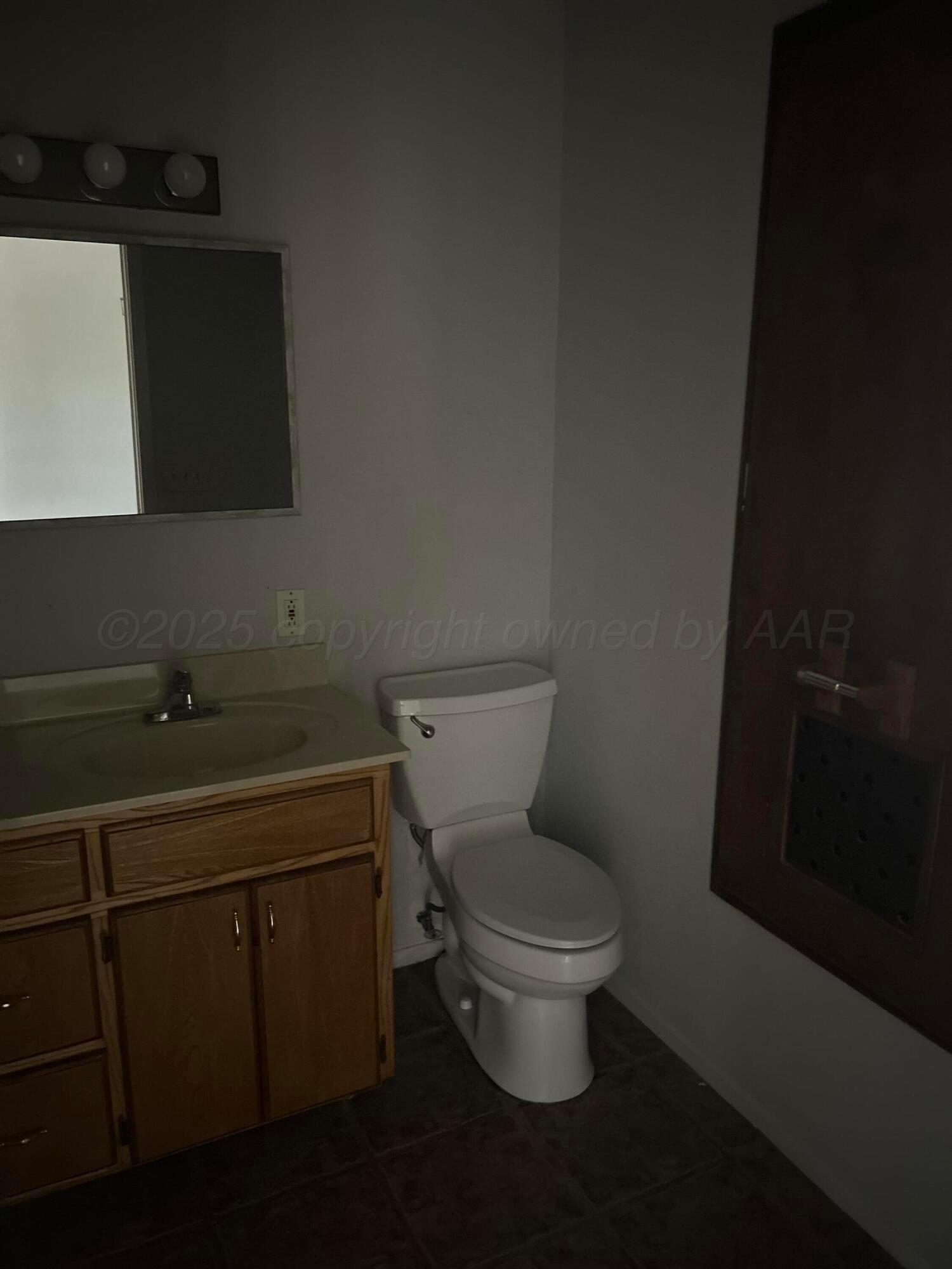 401 Mesa View Miami, TX 79059 - Photo 6 of 11 a bathroom with a toilet sink and mirror