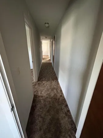 a view of a hallway with windows
