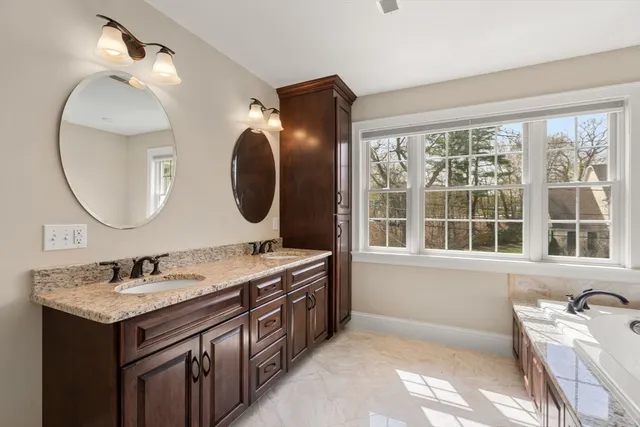 a bathroom with a granite countertop toilet a sink and a mirror