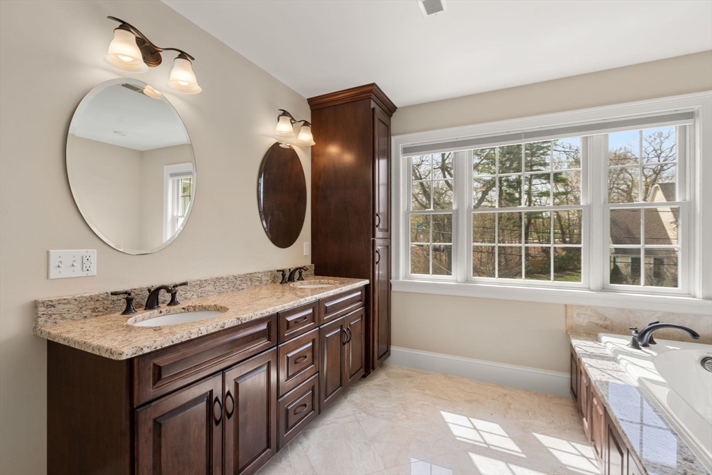 50 Sterling Road Needham, MA 02492 - Photo 13 of 29 a en suite bathroom with a double vanity sink and a mirror