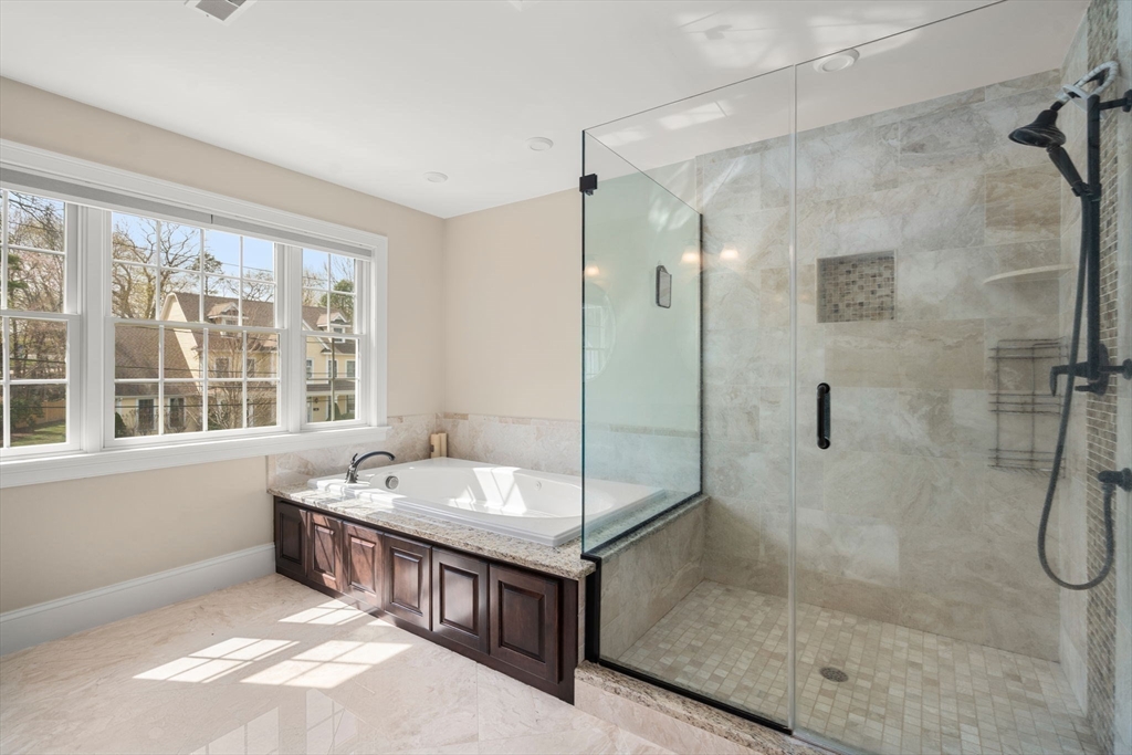 50 Sterling Road Needham, MA 02492 - Photo 14 of 29 a bathroom with a tub sink shower and mirror