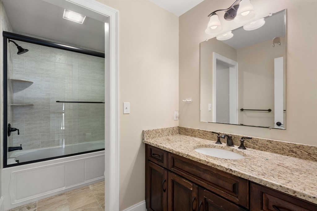 50 Sterling Road Needham, MA 02492 - Photo 18 of 29 a bathroom with a granite countertop sink mirror and a shower