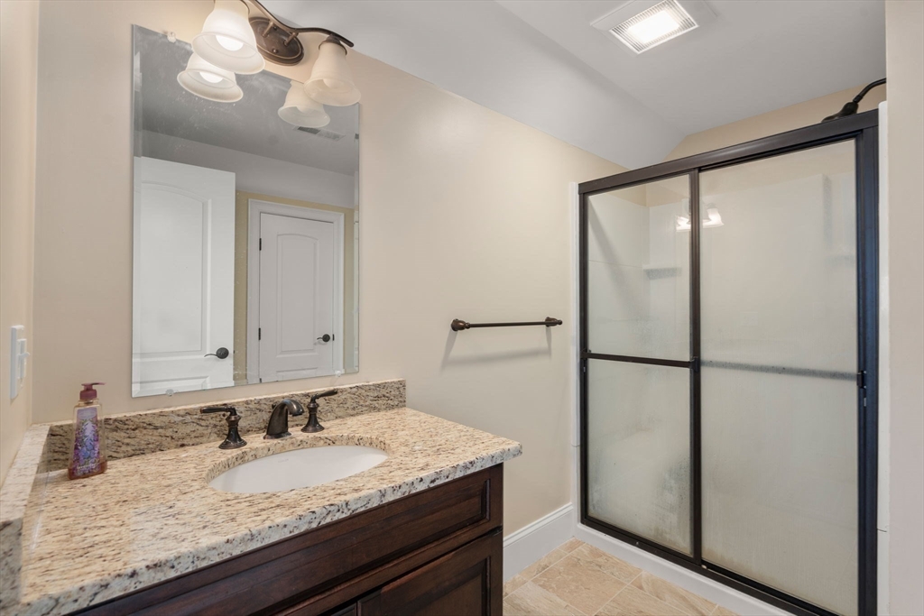 50 Sterling Road Needham, MA 02492 - Photo 21 of 29 a bathroom with a granite countertop sink and a mirror